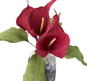 Dieprode calla's van crêpepapier met lang groen blad in een vaas